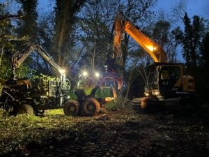Forwarder collecting timber by night
