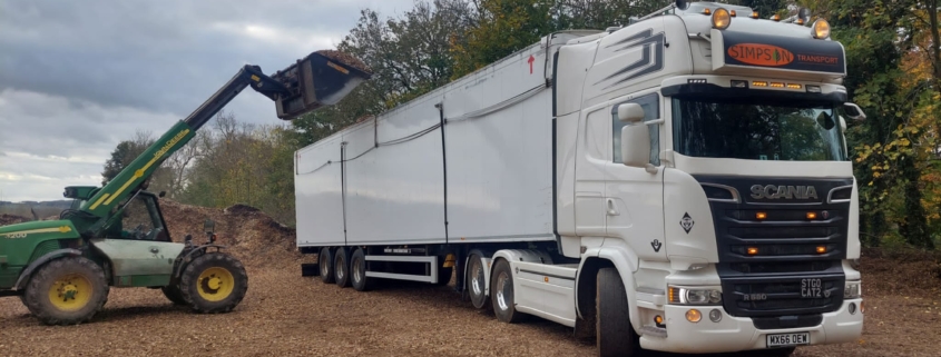 Loading lorry with wood chip - site clearance