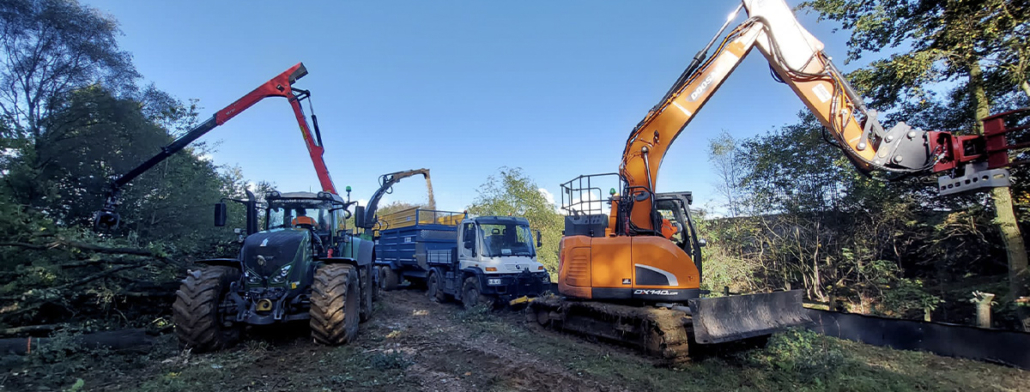 Grapple saw removing and chipping whole trees at a site clearance